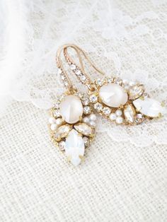 The beautiful combination of Ivory Cream and Opal has an enchanting and vintage appeal! This dainty design made with Swarovski crystals and tiny pearls will certainly add that something special to your bridal look. Unique Gold Earrings, Earrings For Bride, Blush Earrings, Pastel Earrings, Gold Earrings Wedding, Earrings Opal, Crystal Bridal Earrings, Blush Bridal, Gold Bridal Earrings