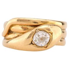 Center Stone: Old Mine Cut Diamond Weight: Approximately .70 Carat Color: J Clarity: SI Metal: 18K Yellow Gold Era: Victorian Circa: 1904's Hallmarks: Birmingham Hallmarks Size: 9.75 and can be resized Gram weight: 8.25 This enchanting Victorian snake ring, crafted in 18K yellow gold, features a captivating .70 carat old mine cut diamond at its center. The diamond, graded J in color and SI in clarity, is beautifully set within the coiled serpent design, a symbol of eternal love and wisdom during the Victorian era. Hallmarked with Birmingham marks and weighing 8.25 grams, this ring from the early 1900s exudes both charm and vintage elegance. Sized at 9.75, it can be resized to fit, making it a stunning and meaningful addition to any fine jewelry collection. Antique Cocktail Ring, Victorian Diamond Ring, Unique Rings Vintage, Old Mine Cut Diamond, Diamond Engagement Rings Vintage, Victorian Rings, Snake Ring, 18k Yellow Gold Ring, Gold Snake