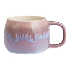 a pink and white mug with blue writing on it