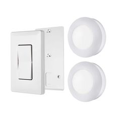 two white light switches and one is on the wall