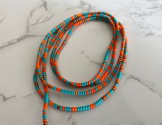 "The Obaa Sweetie handcrafted waist beads for all body types. These waist beads are designed to be tied on for long-term wear. Obaa means \"woman\" in the Akan language of Ghana, translating Obaa Sweetie to \"Sweet woman.\"   C O L O R  The color turquoise represents self-awareness. Orange symbolizes courage and vitality, and bronze exudes nature's aura and ideas of growth and strength.   M E A S U R E M E N T  0 - 55 Inches available. Know your measurement before ordering by measuring your wais Colorful Oval Beads Bracelets For Beach, Colorful Oval Beads Bracelet For Beach, Bohemian Heishi Beaded Waist Beads, Colorful Oval Beaded Bracelets For Beach, Colorful Beads Lariat Necklace For Beach, Colorful Heishi Waist Beads, Oval Tiny Beads Bracelets For Beach, Bohemian Oval Beads Waist Beads For Festival, Beach Beaded Bracelets With Tiny Oval Beads