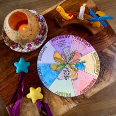 a wooden table topped with toys on top of it and a paper plate next to it