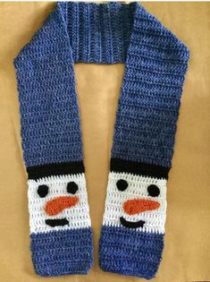 a knitted scarf with a snowman face on it