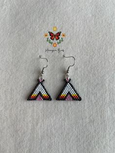 a pair of triangle shaped beaded earrings