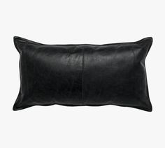 a black leather pillow on a white background