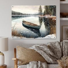 a living room with a couch, table and painting on the wall above it that has a boat sitting in the water