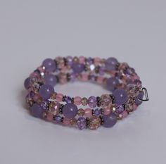 "Lavender Aura"- This piece is subtle and soft yet elegant. With pastel pinks and purples, this bracelet will add sparkle to your day. Lavender Aura comes packaged inside a hand crocheted, cat shaped pouch for safekeeping. This piece is ready to ship today! Lavender Bracelets With Spacer Beads As Gift, Lavender Bracelets With Spacer Beads For Gift, Lavender Adjustable Beaded Crystal Bracelet, Adjustable Lavender Bracelets With Spacer Beads, Adjustable Lavender Bracelet With Faceted Beads, Lavender Beaded Crystal Bracelet As A Gift, Lavender Beaded Crystal Bracelet For Gifts, Hand-strung Pink Amethyst Bracelets, Hand-strung Pink Amethyst Bracelet