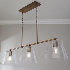 three lights hanging from the ceiling in a room