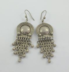 Silver Chandelier Earrings With Dangling Beads, Silver Chandelier Earrings With Dangling Beads For Festivals, Vintage Silver Chandelier Earrings With Latkans, Round Chandelier Earrings With Dangling Beads, Vintage Metal Danglers, Metal Chandelier Earrings With Dangling Beads, Unique Silver Chandelier Earrings With Dangling Beads, Round Metal Chandelier Earrings With Dangling Beads, Vintage Silver Round Chandelier Earrings