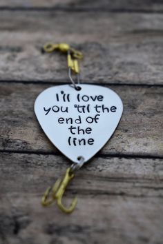 a white heart shaped keychain that says i'll love you till the end of the line