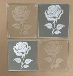 four glass coasters with flowers on them in the shape of roses, and leaves