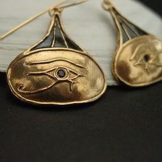 Hand carved ancient Egypt eye of Horus earrings.The Eye of Horus is an ancient Egyptian symbol of protection, royal power, and good health. The Eye of Horus is similar to the Eye of Ra, which belongs to a different god, Ra, but represents many of the same concepts.The eye of Horus was often used to symbolise sacrifice, healing, restoration, and protection.Funerary amulets were often made in the shape of the Eye of Horus. The symbol "was intended to protect the pharaoh in the afterlife" and to wa Symbolic Teardrop Jewelry With Matching Earrings, Symbolic Bronze Drop Earrings, Handmade Symbolic Yellow Gold Earrings, Symbolic Teardrop Earrings, Symbolic Engraved Gold Earrings, Gold Engraved Symbolic Earrings, Engraved Gold Symbolic Earrings, Symbolic Hand Forged Earrings As Gift, Egypt Eye