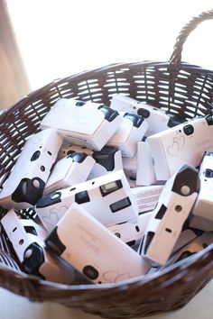 a basket filled with lots of white and black nintendo wii game controllers