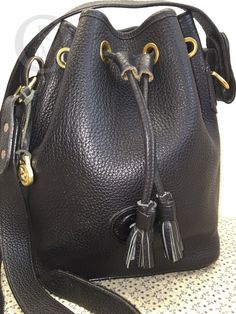 Vintage, Dooney & Bourke, All Weather Leather, black with black trim drawstring bucket bag standing 11" tall x 9" wide x 4" deep with a slide buckle adjustable strap which will allow you to have a 13" to 26" strap drop.  This bag is in excellent condition-No piping problems with this bag- pristine. The item photographed is the actual item for sale.  Smoke free environment. Please look closely at the pictures as they are part of the description.  If the listing does not have the make an offer opt Bucket Purse, Black Bucket, Ladies Handbags, Drawstring Bucket Bag, Bag Stand, Goodie Bags, Black Trim, Dooney Bourke, All Black