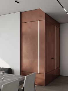 a dining room with a table and chairs next to a tall brown cabinet on the wall