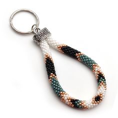 a beaded keychain with two different colored beads and a silver metal clasp