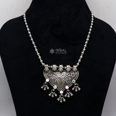 An Indian silver long necklace is a timeless piece of jewellery that can add elegance and sophistication to any outfit. With its intricate design, high-quality 925 silver material, and versatility. An Indian silver long necklace can be worn with a variety of outfits and for different occasions. It can be paired with traditional Indian clothing such as sarees, salwar kameez, or lehenga cholis, or worn as a statement piece with Western clothing such as dresses or blouses. Metal-925 sterling silver Silver Necklace With Intricate Design Fusion Style, Fusion Style Silver Necklace With Intricate Design, Silver Fusion Necklaces With Intricate Design, Fusion Style Silver Temple Necklace With Tilla, Silver Temple Necklace In Metal, Silver Fusion Necklace With Intricate Design, Festive Silver Necklace With Tilla Detailing, Fusion Style Silver Necklace For Festivals, Silver Fusion Style Necklace For Festivals