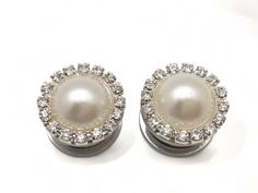 "Faux pearl plugs pretty enough for any bride adorned with a faux faint ivory pearl surrounded by rhinestones Sold in Sets 5/8\" 16mm gauge size Pearl rhinestone cap is 20mm Available plug materials: Surgical steel screw back tunnels OR wood single flared tunnels with o-ring Other sizes: 1/2\" 9/16\" 7/16\" https://www.etsy.com/prettyvagrant/listing/214431236 0g 2g 4g 6g https://www.etsy.com/prettyvagrant/listing/250097679 Made to order.  Please allow a couple days to create. Shipped in a gift b Nickel-free Sterling Silver Plug Earrings For Wedding, Elegant Clip-on Plug Earrings For Wedding, Elegant Clip-on Plug Earrings, Nickel-free White Round Plug Earrings, Elegant Gold-tone Plug Earrings, Crystal Plugs, Ivory Pearl, Gauged Earrings, Plugs Earrings