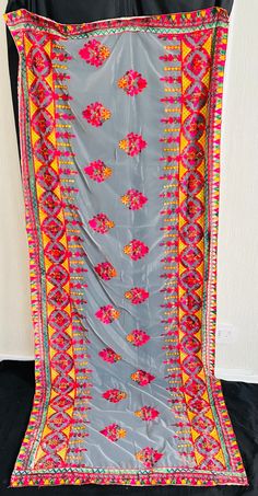 Phulkari hand-made multi-coloured thread Dupatta on a soft net material. Bordered edges and embroidery work all over the Dupatta.  Dupatta available in different colours. Perfect for Mehndi, weddings, party, and events. Great statement Dupatta/shawl for any outfit.  Any questions, please feel free to contact us. Statement Dupatta, Shawl Dupatta, Embroidery Dupatta, Phulkari Embroidery, Different Colours, Embroidery Work, Dress Clothes For Women, Shawl, Hand Made