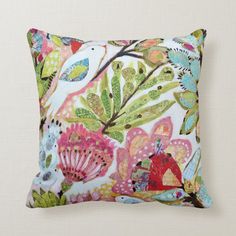 a colorful pillow with birds and flowers on it