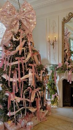 a decorated christmas tree with pink ribbons and bows