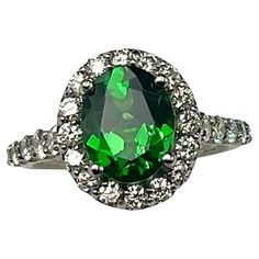 an oval green and white diamond ring