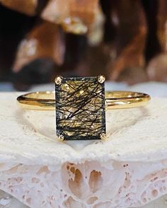 The unique setting contains a 2.00ct natural rutilated Quartz. The stone measures 9x7mm. Each stone is unique. The ring is available in sterling silver and 14k white, yellow and rose gold. This ring makes a great gift for a birthday, Mother's Day, bridesmaid, or any other special occasion. Please send me a message if you need a size not listed. All items are handmade by me in my shop in Manalapan, NJ. This ring can be customized with any color stone. Please message me with any questions. Shippin Black Rutilated Quartz Ring, Emerald Cut Sapphire Ring, Green Amethyst Earrings, Ring Emerald Cut, Black Rutilated Quartz, Rutilated Quartz Ring, Tourmalinated Quartz, Ring Emerald, Tourmaline Ring