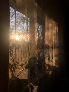 the sun is shining through an open window with frosted glass covering it's windows