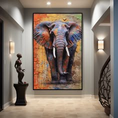 an elephant painting hanging on the wall next to a statue in a room with tile flooring