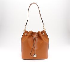 Sleek and sophisticated, this chic drawstring bag is fashioned with rich leather and a roomy interior that's ready to carry all your essentials. From Dooney & Bourke. Leather Drawstring Bags, Drawstring Bucket Bag, Leather Bucket Bag, Leather Bucket, Dooney & Bourke, Hobo Handbags, Dooney Bourke, Fashion Handbags, Drawstring Bag