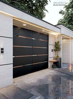 a modern garage with an open door and planters on the side of the building