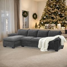 a living room with a couch and christmas tree in the backgroung area