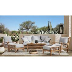 an outdoor living room with furniture and plants