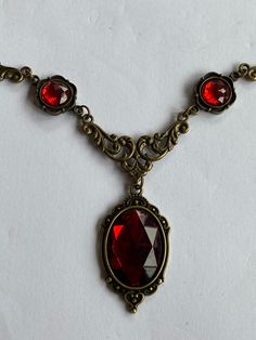 STUNNING FILIGREE VICTORIAN STYLE Red Dark Gold PLATED NECKLACE (BRONZE COLOUR) FASTENS WITH TRIGGER CLASP.  PENDANT APPROX  1.75 INCHES (4cm) INCLUDING BAIL LENGTH OF NECKLACE...16..INCHES (40cm)   AS SHOWN... OTHER LENGTHS ALSO AVAILABLE 18 20 22 24 inches  longer lengths have more parts and or stones Also listed as a set with earrings....WITH CHOICE OF 3 SIZES OF EARRINGS. see other listings for the sets I am gradually adding different colour listings as I make them. Let me know if there is a Red Necklace Set, Bronze Colour, Red Necklace, Red Dark, Dark Gold, Gold Plated Necklace, Victorian Style, Bronze Color, Victorian Fashion