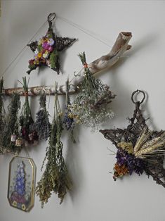 an image of some flowers hanging on the wall with other things attached to it's sides