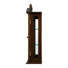 a wooden grandfather clock with glass shelves on the top and bottom shelf, in front of a white background