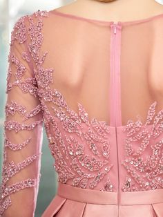 the back of a woman's pink dress with sequins and beading