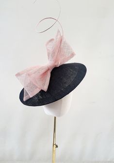 Presenting a beautiful black saucer sinamay percher hat with a pink bow and ostrich quill detail. Attached by satin covered headband.  If you would like a different colour combination or monotone please get in touch. The hat base measures 30 cms in diameter approximately meeting the Royal Enclosure requirements for Ascot. If you would like the design customising at all, or an alternate colourway please get in touch with me and I will be delighted to help.  Handmade to order in the UK at our York studio by Design By Hummingbird who've been featured in Vogue, Marie Claire, Cosmopolitan and on the New York Runway! Follow us on Instagram @designbyhummingbirdofficial Saucer Hat, Adjustable Fedora For Royal Ascot, Adjustable Cloche Boater Hat For Church, Adjustable Fedora Mini Hat For Church, Adjustable Fedora Fascinator For Church, Adjustable Fedora-style Fascinator For Church, Fedora For Races, Black Boater Hat With Short Brim For Races, Adjustable Black Hat For Royal Ascot