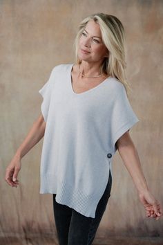 Elevate your layering game with the Devyn Vest, a versatile essential that adds a touch of charm to any outfit. A lightweight cami, collared shirt, or romantic blouse would benefit from this essential topper, designed to mix-and-match with our coordinating Cleo Sweater Pants. Part of our Mix-and-Match Knitwear capsule. Classic fit. One size fits most. Short sleeve, open-side sweater with mother-of-pearl button closure, ribbed hemline. Italian knit blend. Hand wash cold, lay flat to dry. Made in Italy. V-neck Top For Daywear In Fall, Fall V-neck Everyday Blouse, Everyday Fall V-neck Blouse, V-neck Top For Fall Daywear, V-neck Blouse For Everyday Fall Wear, Chic Relaxed Fit Tops For Layering, Chic Tops For Layering With Relaxed Fit, Versatile V-neck Tops For Daywear, Versatile Tops With Shirttail Hem For Daywear