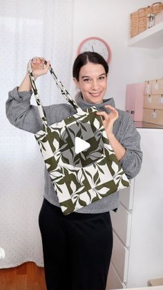 a woman holding onto a green and white bag