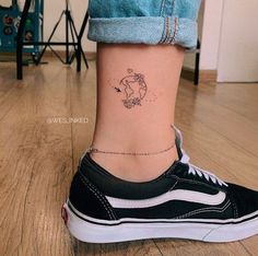 a woman with a small tattoo on her ankle