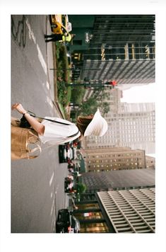 a woman standing on the side of a building with her legs up in the air