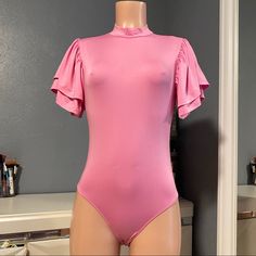 New Without Tags Pink Ruffle Sleeve Bodysuit It’s Super Stretchy Pit To Pit 16 1/2 Inches Length 28 Inches Color Is A Barbie Pink Fitted Ruffles Bodysuit For Night Out, Flirty Fitted One-piece Bodysuit, Solid Color Short Sleeve Bodysuit For Party, Fitted One-piece Bodysuit With Ruffles, Fitted Ruffles Bodysuit, Trendy Fitted Bodysuit With Ruffles, Fitted Ruffles Bodysuit For Spring, Chic Fitted Pink Bodysuit, Feminine Fitted Spring Bodysuit