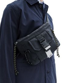 A.P.C. Men's belt bag. - Durable material.- One large compartment.- Front pocket with A.P.C.-logo buckle closure.- Side pocket.- 'Climbing rope' zip pull.- Black snap hook clasp engraved with white A.P.C. logo.- Label on back with space for name and address. Apc Bag, Sling Bag Mini, White Shirt Men, Short Blouses, White Shirts Women, Faux Leather Bag, Exclusive Clothing, C Logo, Men's Belt