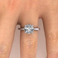 a woman's hand with a diamond ring on it