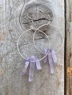 Raw purple quartz crystal points in gold or silver hoop earrings with French hooks. Perfect little boho look. Light weight and easy to wear. Add these to your boho outfits and make a 💜Healing clear quartz Crystal property has been know for centuries to restore balance in the body. -Options- 30mm as shown 21 gauge hoops Total drop Length: 2.3 inches 14k Gold filled hoops Sterling silver hoops Gold plated hoops Silver plated hoops All comes with hooks Simple, Dainty, Delicate, yet so Elegant and Bohemian Wire Wrapped Hoop Jewelry, Purple Bohemian Everyday Jewelry, Adjustable Gemstone Hoop Jewelry, Purple Dangle Hoop Earrings With Ear Wire, Nickel-free Purple Dangle Hoop Earrings, Purple Nickel-free Dangle Hoop Earrings, Bohemian Wire Wrapped Round Crystal Earrings, Handmade Bohemian Crystal Hoop Earrings, Bohemian Wire Wrapped Hoop Crystal Earrings