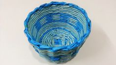 a blue basket sitting on top of a white table