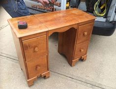 a wooden desk sitting on top of a sidewalk