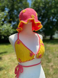 Yellow O ring bralette top with pink flowers and detailing. The hat in these pictures is also available on my Etsy shop so be sure to add it to your cart as well for a cute set!  -This top is a small/medium  -This top fits C/D cups Trendy Fitted Beach Hats, Pink Crochet Hat For Summer Vacation, Pink Bohemian Crochet Hat For Summer, Bohemian Pink Crochet Hat For Summer, Fitted Crochet Hat For The Beach, Fitted Crochet Hat For Spring, Trendy Fitted Festival Hats, Cute Pink Crochet Hat For Beach, Fitted Crochet Bucket Hat For The Beach