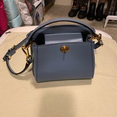 Cutest Satchel Bag In Brand New And Perfect Condition, Color Blue, Size 7.5w X 5.5h Blue Formal Satchel With Branded Hardware, Blue Office Satchel With Branded Hardware, Light Blue Formal Crossbody Shoulder Bag, Formal Light Blue Crossbody Shoulder Bag, Light Blue Top Handle Shoulder Bag With Gold-tone Hardware, Light Blue Formal Bags With Gold-tone Hardware, Formal Light Blue Bags With Gold-tone Hardware, Light Blue Leather Bags With Gold-tone Hardware, Blue Formal Bucket Bag